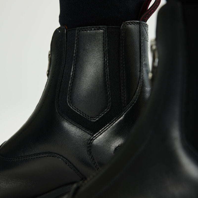 LeMieux Adults Zip Paddock Boot Black shown with black socks and detailed stitching.