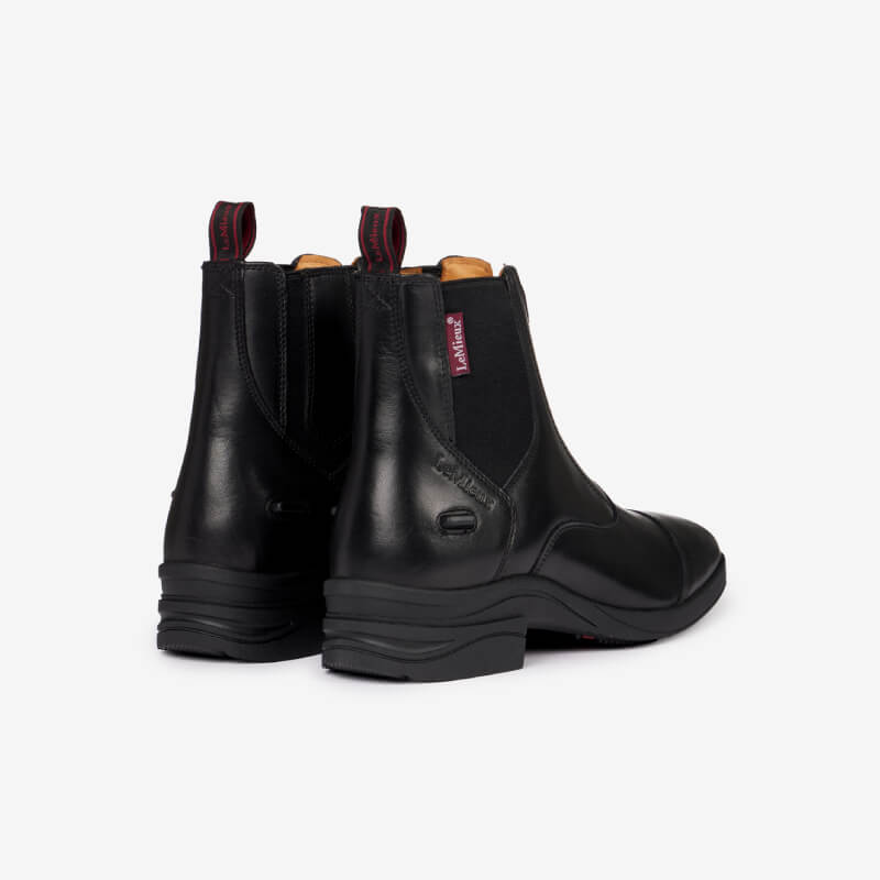 LeMieux Adults Zip Paddock Boot Black with side elastic panels and pull tabs, rear view.