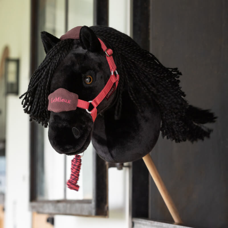 LeMieux Hobby Horse with Vogue Headcollar Cranberry, black plush, yarn mane, wood stick handle.