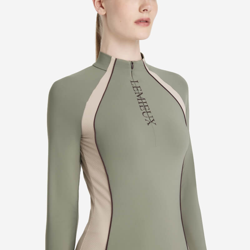 Woman in a fitted rosemary LeMieux Phillipa Mesh Baselayer with chest logo.