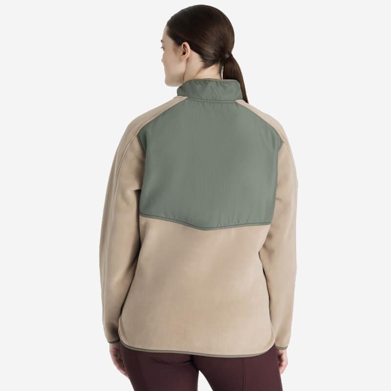 Woman modeling the LeMieux Clara Hybrid Fleece Rosemary, shown from the back against a plain backdrop.