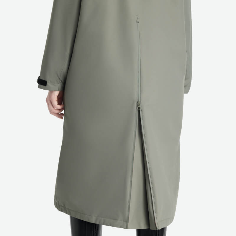Back of LeMieux Hydroshield Robe Rosemary, worn over black pants, with zipper vent.