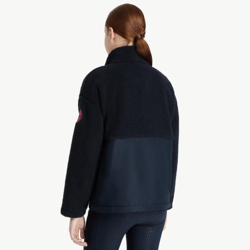 LeMieux Young Rider with auburn ponytail in Navy Tammy Teddy Fleece, shown from the back.