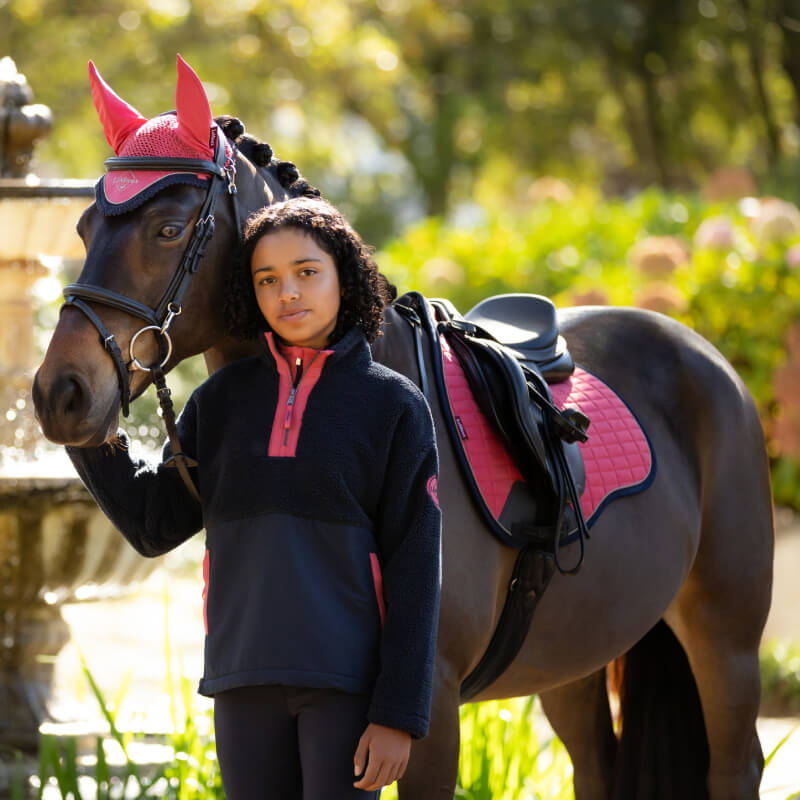 Girl and horse in matching LeMieux Young Rider Tammy Teddy Fleece Navy outdoors.
