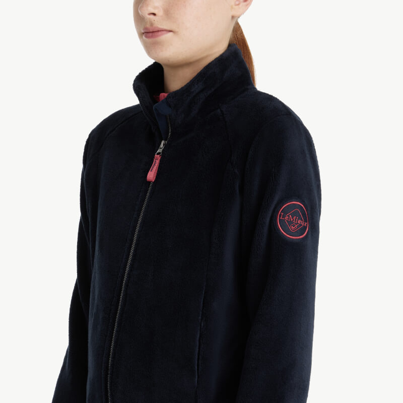 LeMieux Young Rider Libby Fleece Navy zip-up jacket, shown worn by a female model.