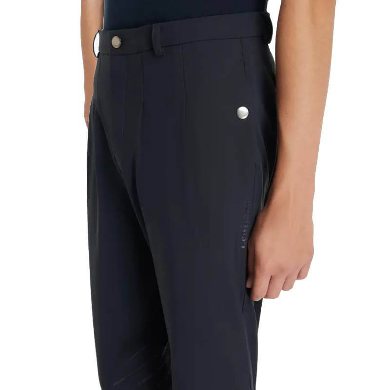 Person in navy LeMieux Young Rider Boys Classique Breech with side pockets, shown from the side.