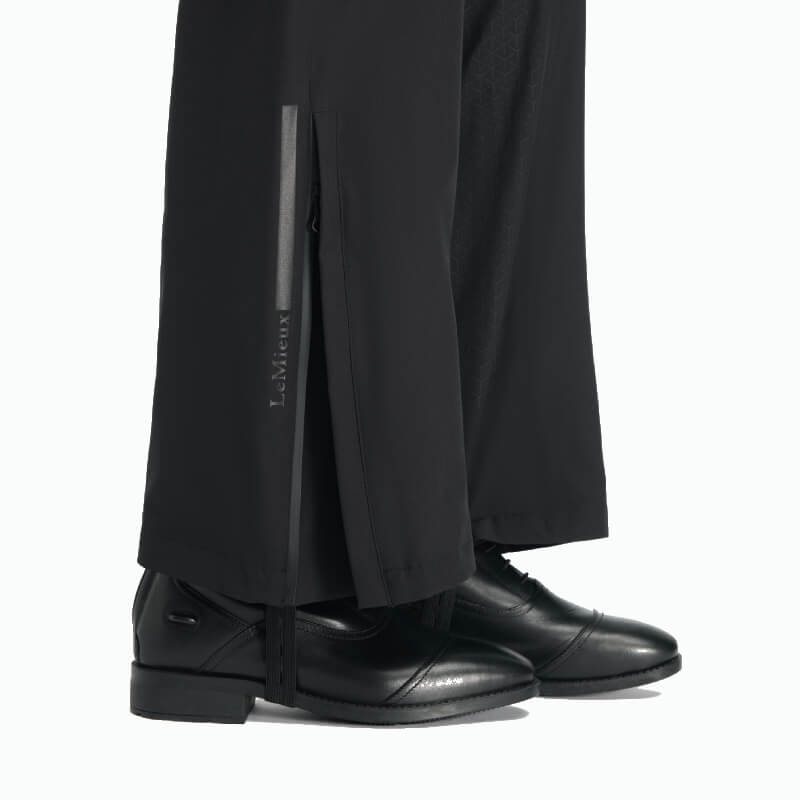 Black dress shoes and LeMieux Young Rider Drytex Stormwear Waterproof Trousers in black.