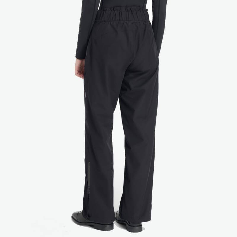 Model wears LeMieux Stormwear Waterproof Trousers Black by LeMieux, shown from the back.