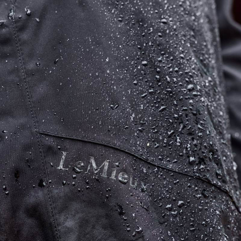 Close-up of water droplets on LeMieux Stormwear Waterproof Trousers in black.