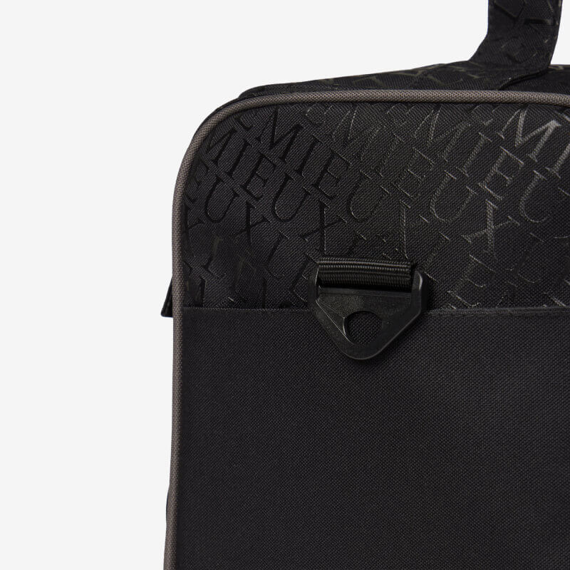 Close-up of the LeMieux Elite ProKit Lite Grooming Bag Black with logo pattern and front clip.