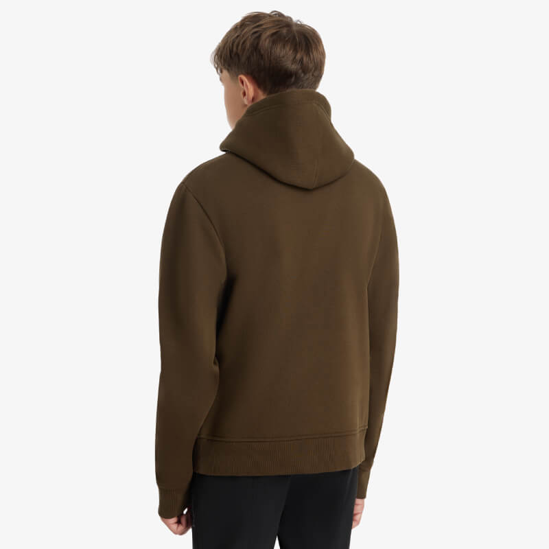 Boy in a LeMieux Young Rider Boys Hoodie Alpine and black pants, facing away on white background.