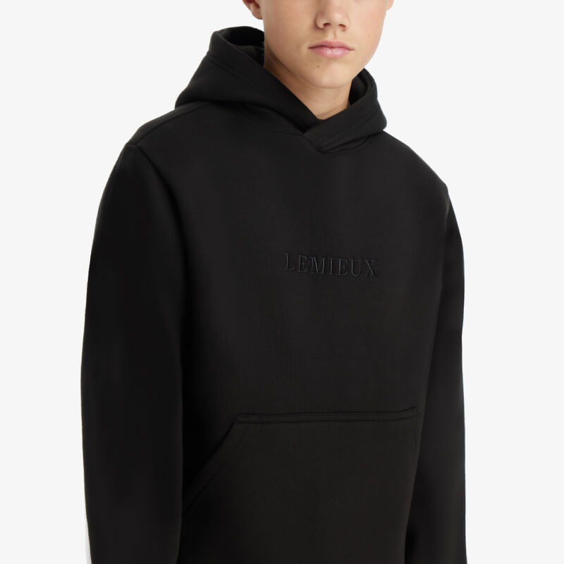 Young model in LeMieux Young Rider Boys Hoodie Black, a fleece-lined hoodie with kangaroo pocket.