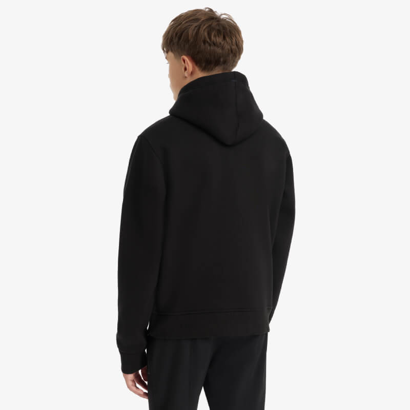 Wearing a LeMieux Young Rider Boys Hoodie Black, facing away against a white background.