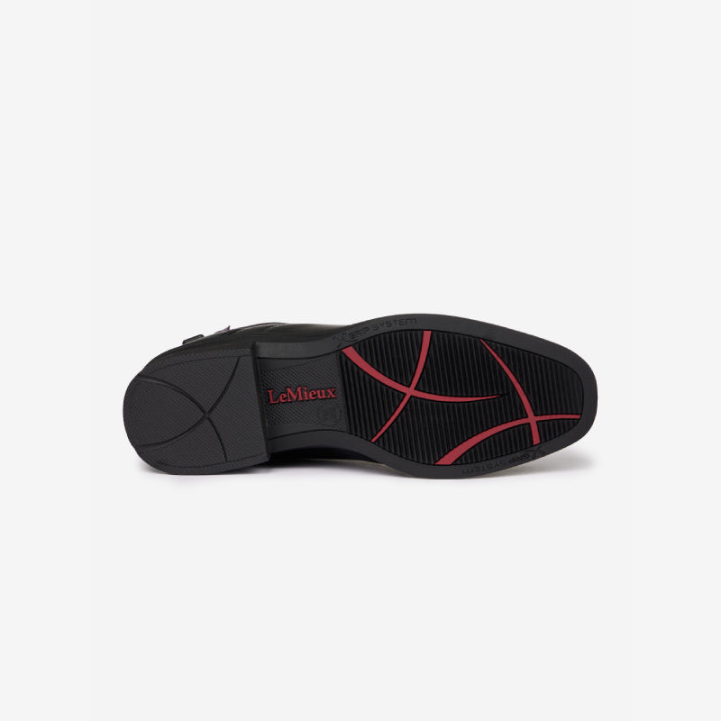 Black sole with red curves and LeMieux logo on Junior Zip Paddock Boot Black for kids.