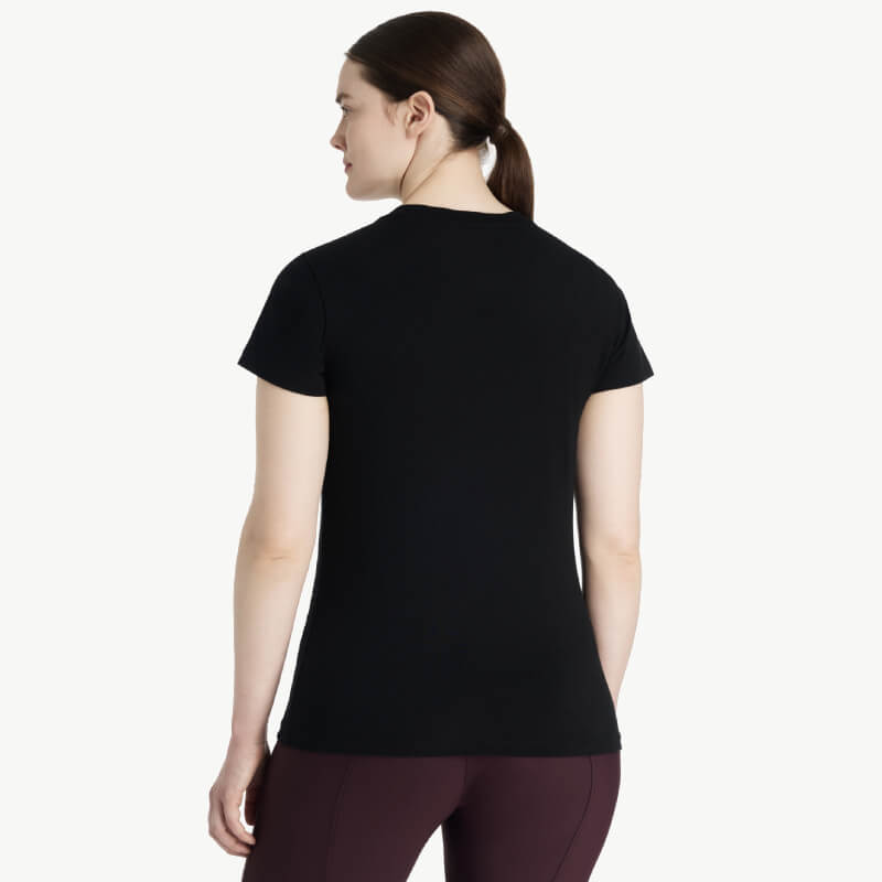 Woman with brown hair wears LeMieux Classique Sparkle T-Shirt Black, facing away.