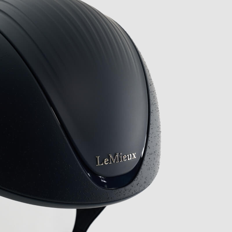 A navy LeMieux Vexa® Skull Helmet with chin straps, designed for equestrian safety.