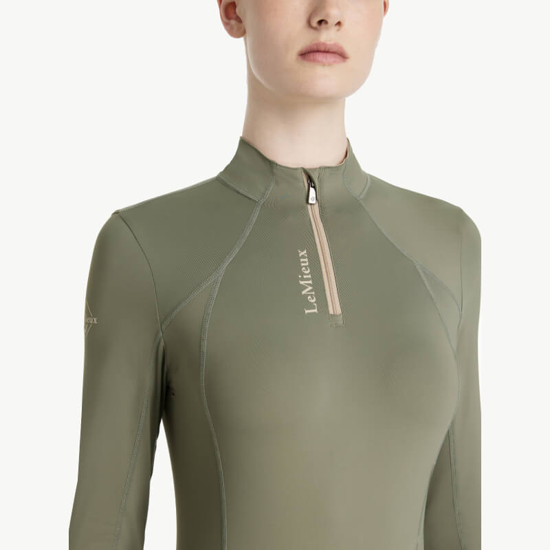 Woman in a LeMieux Classique Baselayer Rosemary by LeMieux, looking sideways.