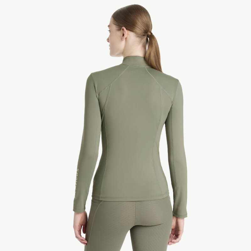 Woman in a LeMieux Classique Baselayer Rosemary, hair in a low ponytail, seen from behind.