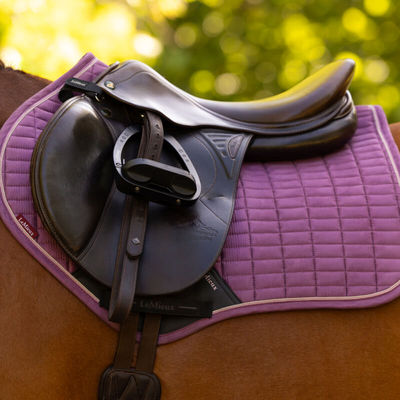 LeMieux Suede Close Contact Square Mallow saddle pad in purple with dark accents.