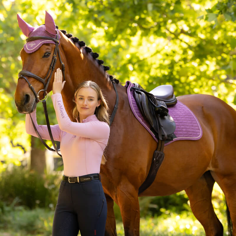 Woman in pink shirt with brown horse in LeMieux Suede Close Contact Square Mallow, outdoors.