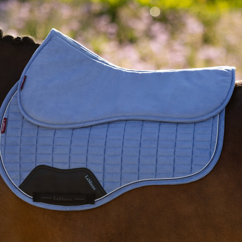 LeMieux Suede Half Pad Powder Blue with black lining, shown on a white background.