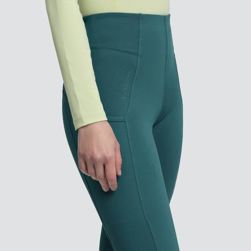 Wearing LeMieux Naomi Pull On Breech Jungle and a pale yellow long-sleeve top, waist to thigh.