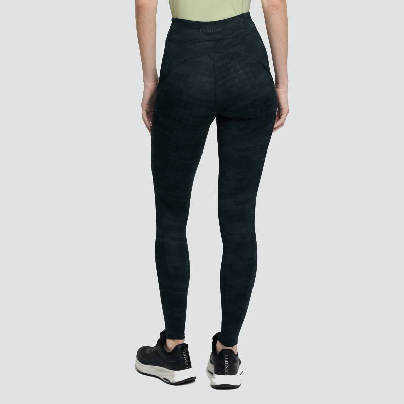 LeMieux Naomi Camo Black pull-on breeches, ankle-length, paired with a green top.