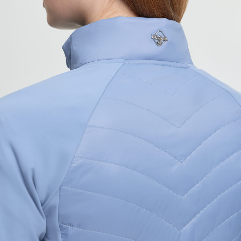 Person in a LeMieux Juliette Jacket Powder Blue with lightweight insulation and small collar logo.