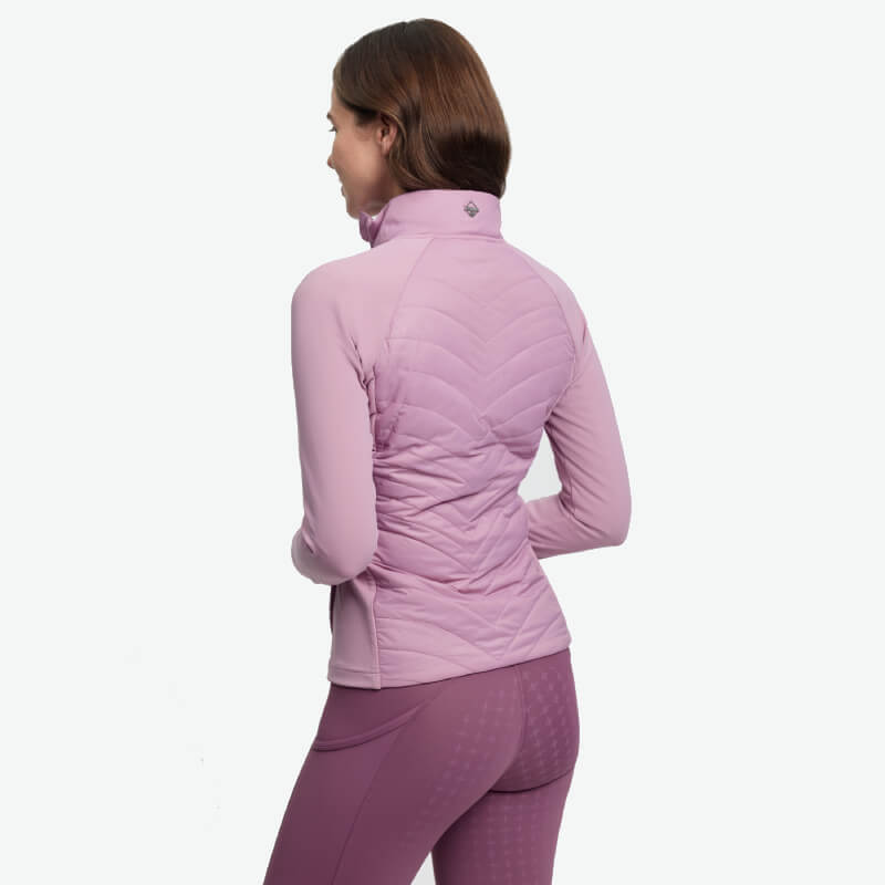 Woman in fitted LeMieux Juliette Jacket Fondant, viewed from back on white background.