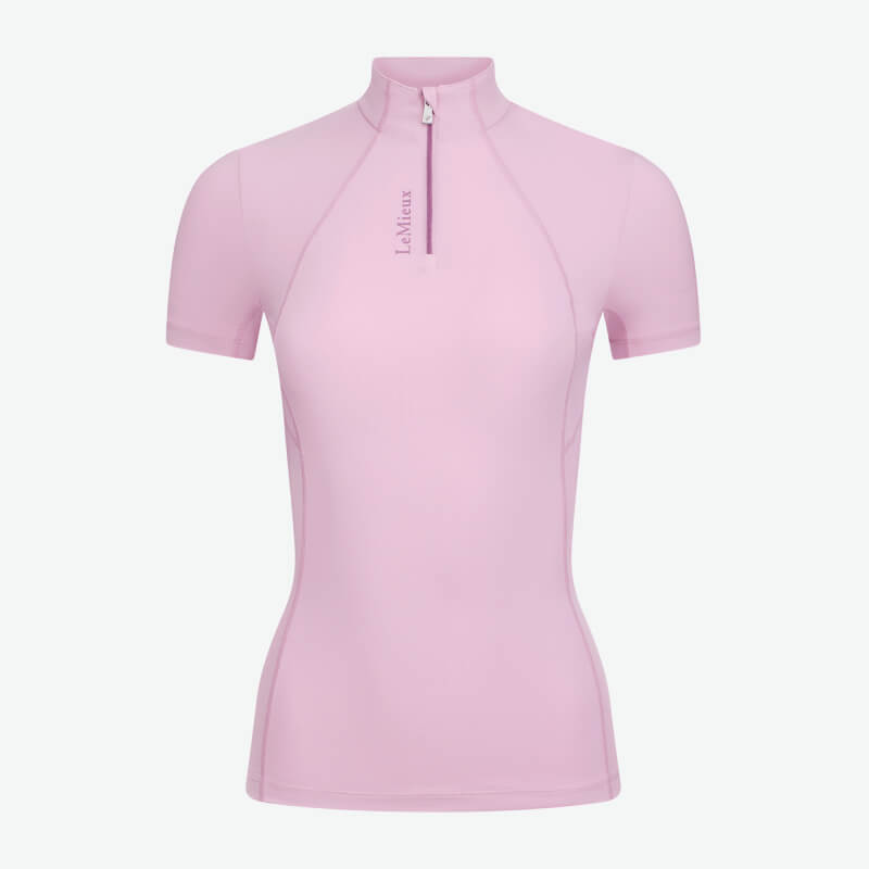 Smiling woman in LeMieux Classique Fondant baselayer, black pants, hand behind back.