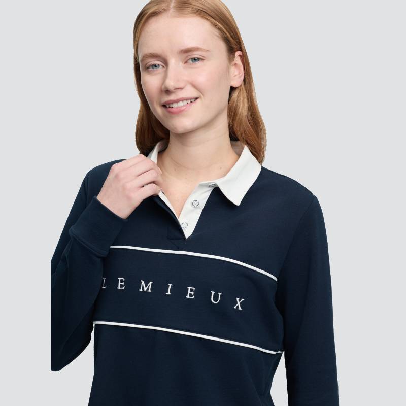 Woman with long hair wears LeMieux Rochelle Rugby Shirt Navy, smiling at the camera.
