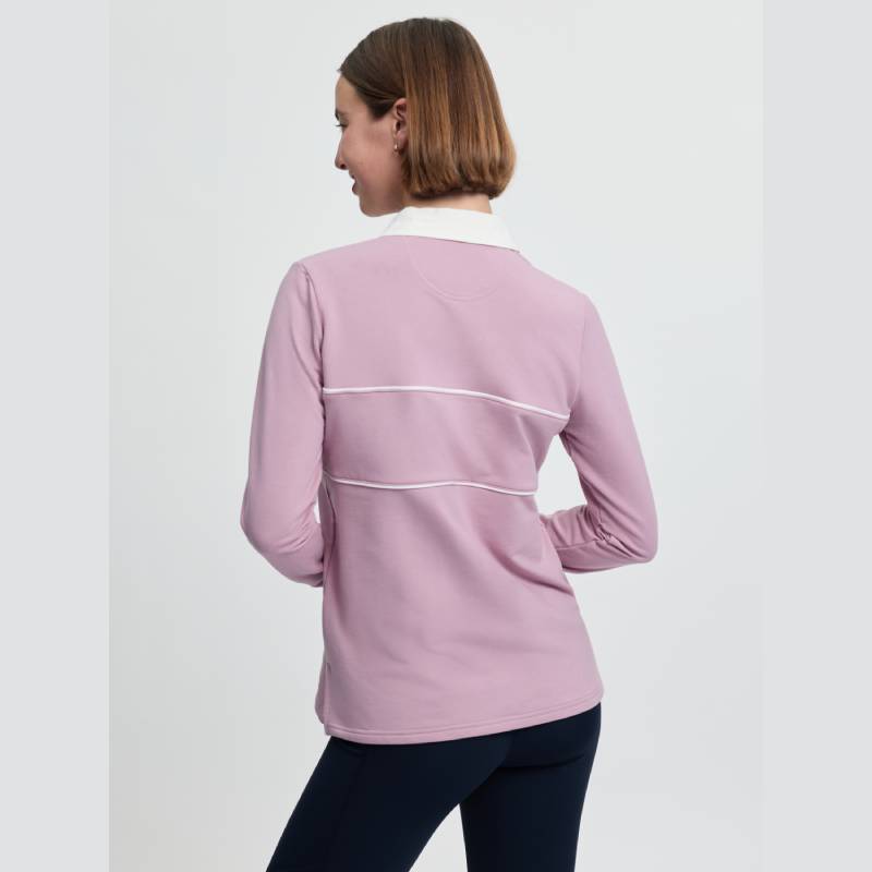 Woman wearing LeMieux Rochelle Rugby Shirt Fondant, hands on hips, facing away.