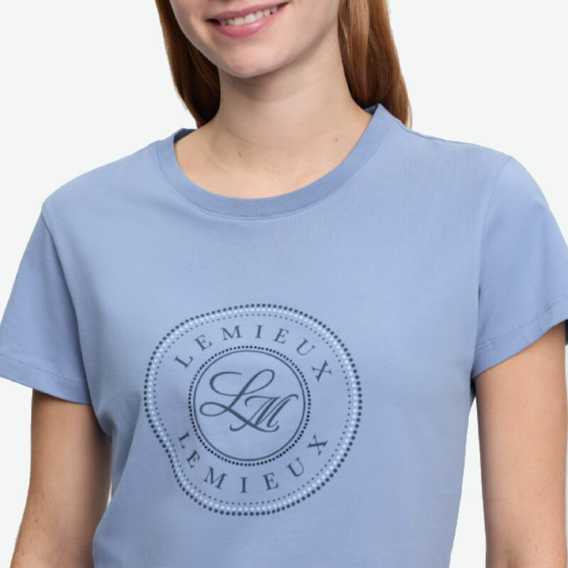 Woman in LeMieux Classique T-Shirt Powder Blue, featuring LM logo and equestrian style.