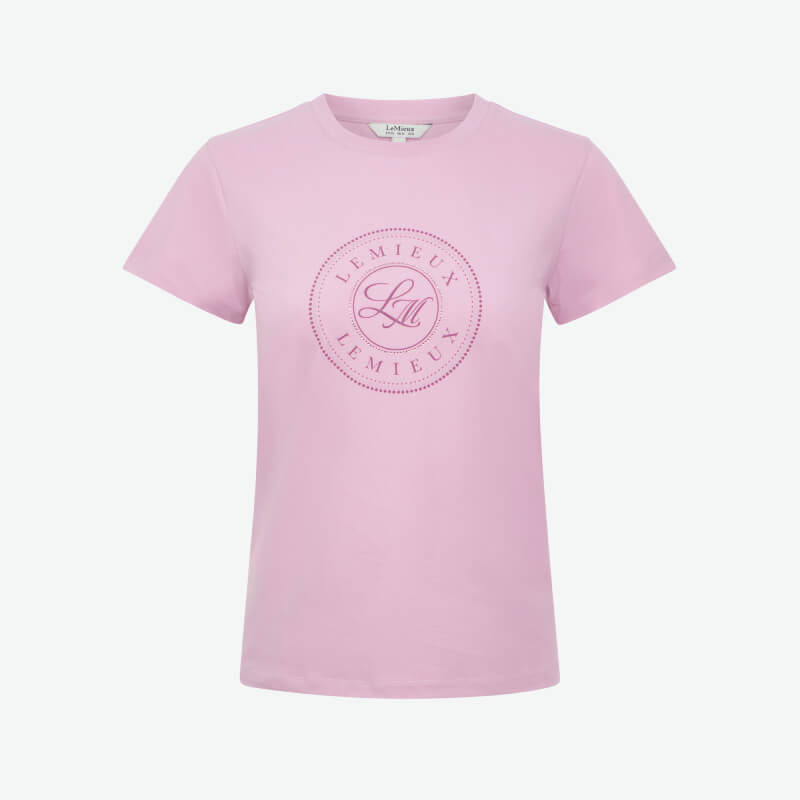Woman in a LeMieux Classique T-Shirt Fondant and light blue leggings smiles at the camera.