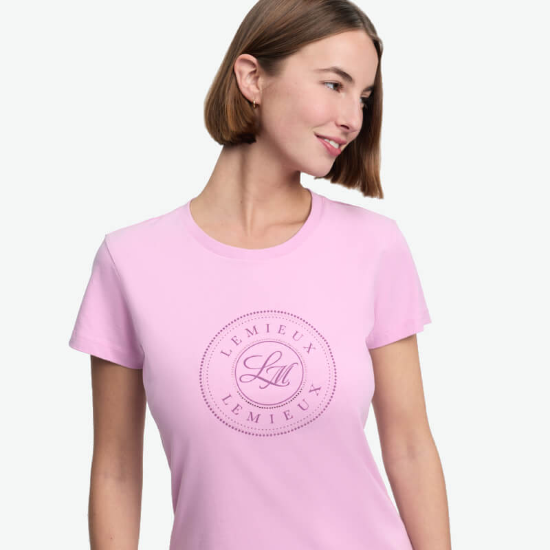 Woman in a LeMieux Classique T-Shirt Fondant looks left, highlighting equestrian style.