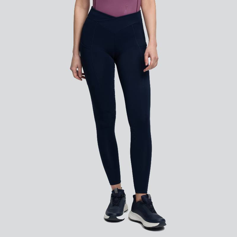 Wearing LeMieux Simone Cross Over Half Seat Pull On Navy, a purple top, and black sneakers.