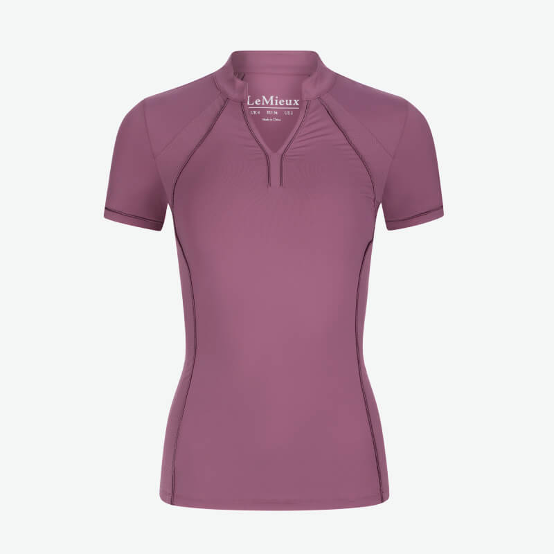 Woman in a LeMieux Lisa Mesh Baselayer Mallow and navy pants stands against a white background.