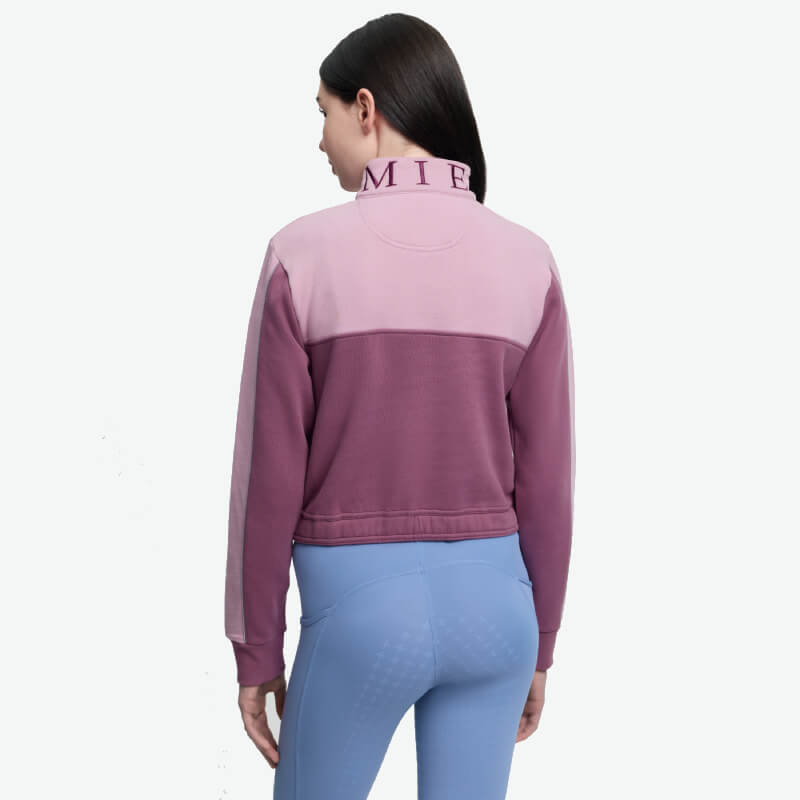 Woman in a LeMieux Young Rider Cropped Kate Quarter Zip Mallow, light blue leggings.