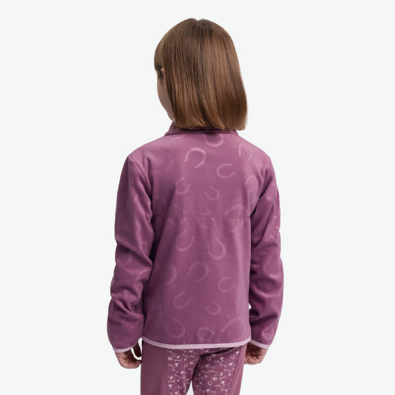A child in a purple LeMieux Mini Maggie Fleece Mallow stands facing away from the camera.