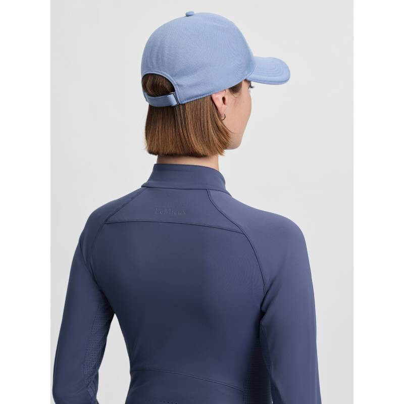 Person wearing a LeMieux Lara Cap in Powder Blue, viewed from behind, plain background.