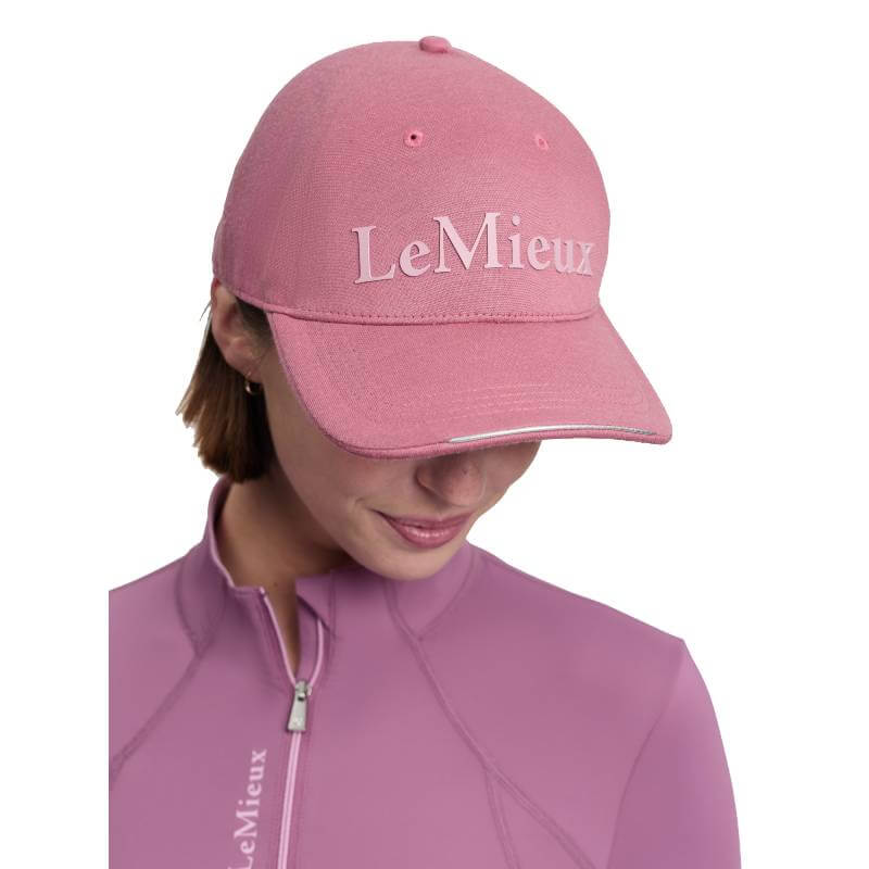 Person in pink top and LeMieux Lara Cap Mallow, logo visible on cotton twill cap and top.