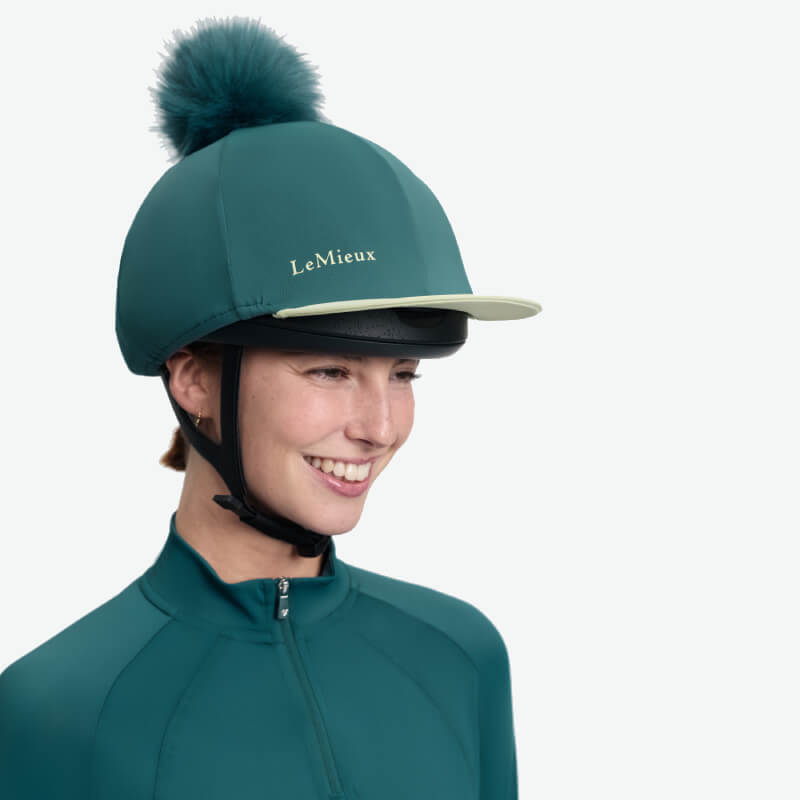 LeMieux Classique Pom Hat Silk Jungle with faux fur pom and side logo in teal.