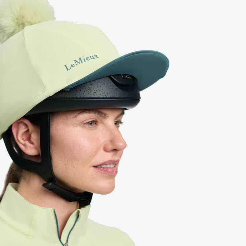 LeMieux Classique Pom Hat Silk Macaron in light yellow with faux fur pom and side logo text.