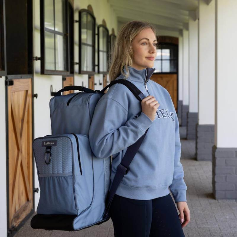 Woman with LeMieux Powder Blue Boot & Hat Bag, ideal for riding accessories.