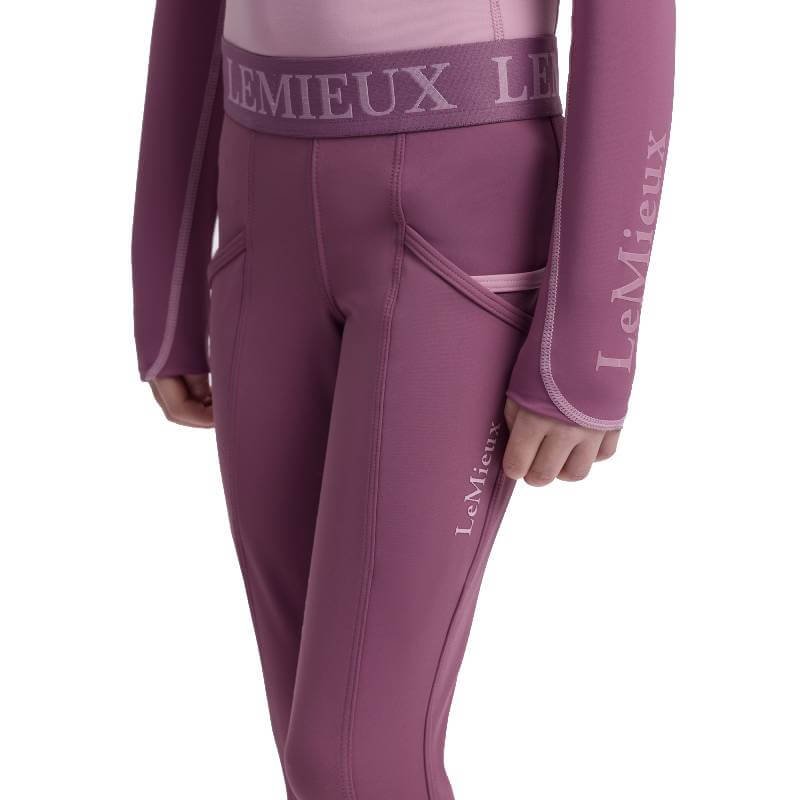 Person in LeMieux Mini Pull On Breech Mallow with LeMieux branding on waistband and sleeve.