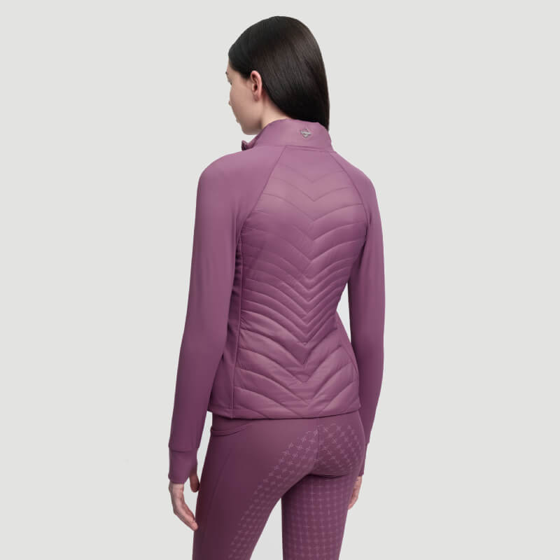 Woman in a LeMieux Young Rider Josephine Jacket Mallow stands against a plain light gray background.