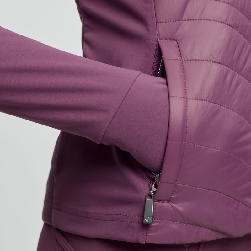 Hand in pocket of a LeMieux Young Rider Josephine Jacket Mallow, close-up view.