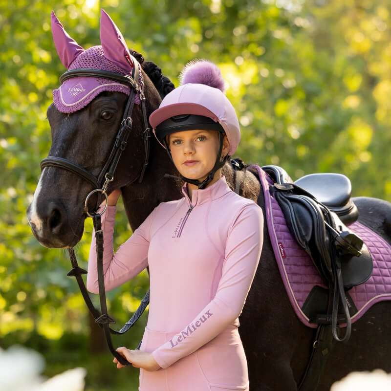Teen girl in LeMieux Young Rider Classique Baselayer Fondant, smiling in sweat-wicking top.