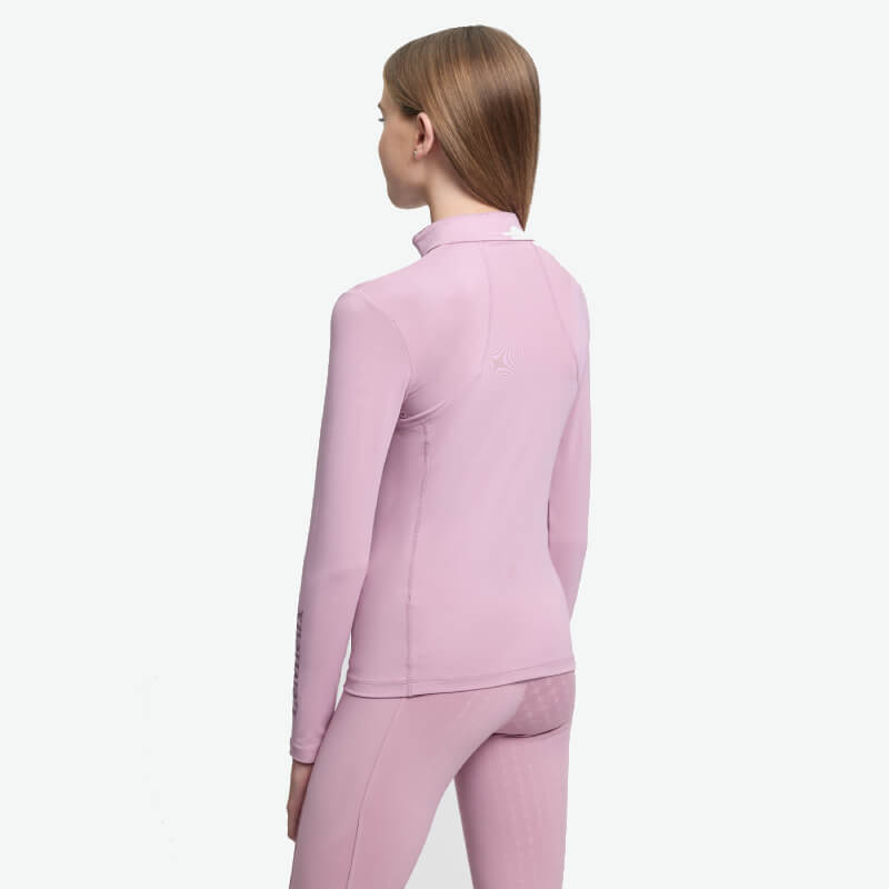 Woman in LeMieux Young Rider Classique Baselayer Fondant, long-sleeve, light pink, back view.