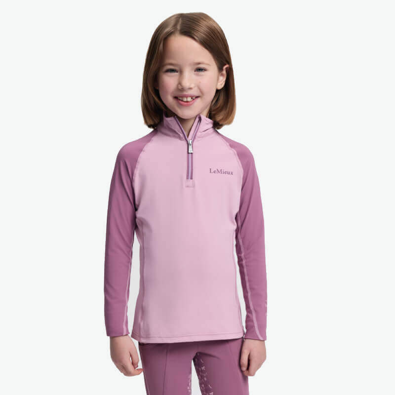 LeMieux Mini Baselayer Fondant: a kids’ riding top with UV50+ protection in light pink.